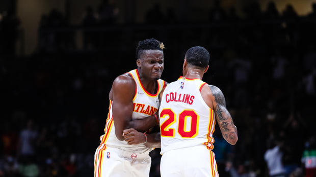 Clint Capela chest bumps John Collins.